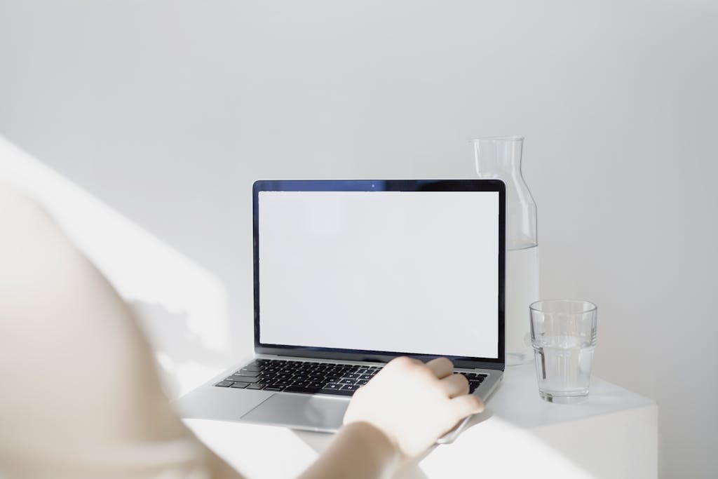 Person Using Macbook Pro on Table